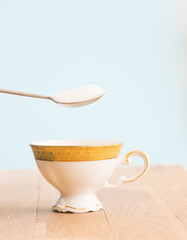 Spoon with sugar and cup