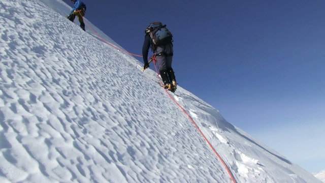 ALTAI , RUSSIA-MAY 2015: Iiktoo mountain, South Chui range, altitude 4000 m. Climber rises on a steep mountain snow slope. 
