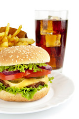 Cropped image of cheeseburger,french fries,glass of cola on plat