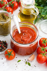 tomato sauce, pesto and ingredients, vertical, top view