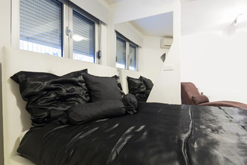 Modern bedroom with black linen