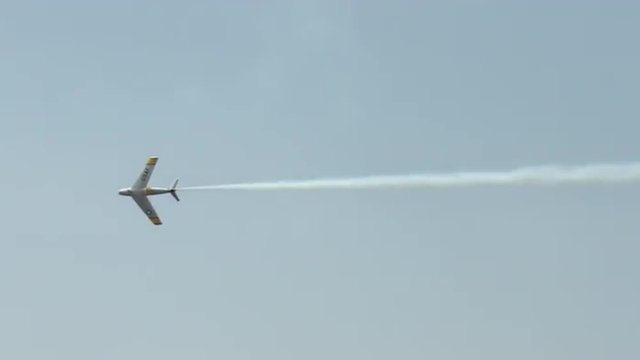 North American F-86 Sabre jet fighter leaves contrails while executing fast maneuvers .  Recorded in 4K, ultra high definition.
