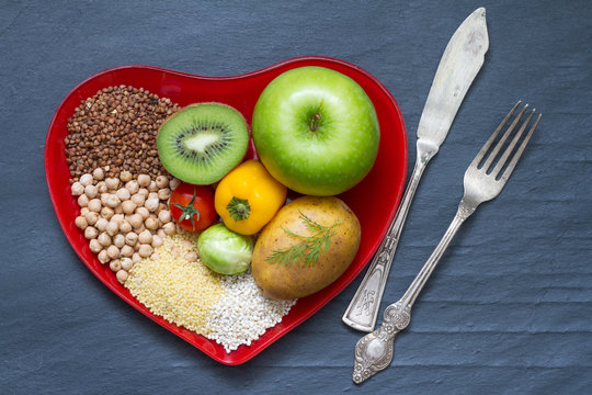 Health food on a red heart plate diets abstract still life

