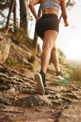 Woman running on rocky trails