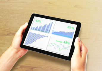 Business chart on digital tablet screen in man hands