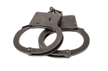 Steel black handcuffs over white background