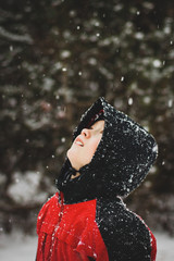 Fototapeta na wymiar Boy looking at the falling snow