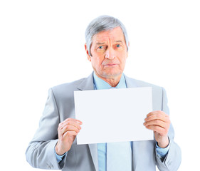 Nice businessman at the age of't holding a big white poster. Isolated on a white background.