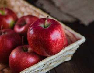 Apples in a basket on wooden background