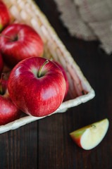 Apples in a basket on wooden background