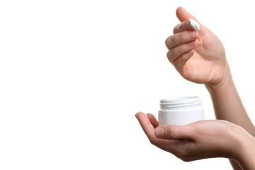 Woman dipping finger into moisturizer cream on white isolated background