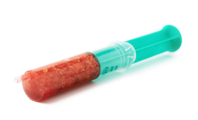 Medical syringe filled with red liquid