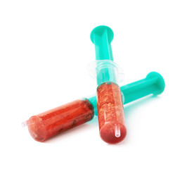 Medical syringe filled with red liquid