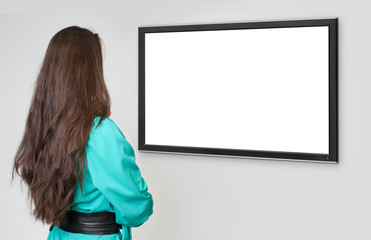back view of young woman looking at tv