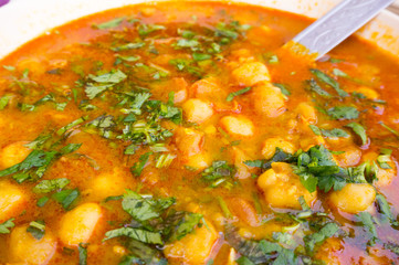 Indian potato gravy dish garnished with coriander