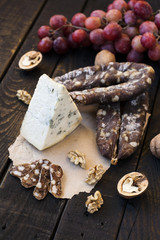 Snacks for wine, cheese with mold, pink grapes, walnuts