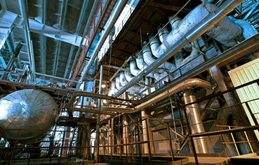 different size and shaped pipes and valves at a power plant 
