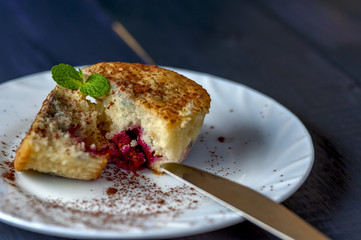 Muffin with cherry and pineapple on white plate