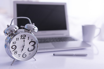 Alarm clock on office desk selecttive focus