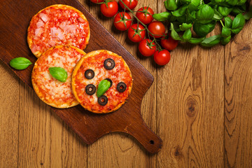 Mix of mini pizzas on wooden board