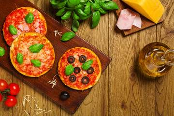 Mix of mini pizzas on wooden board