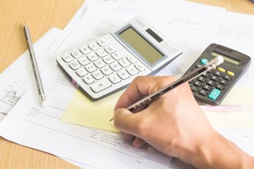 a calculator is on a balance sheet numbers are statistics. photo