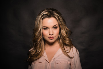 Fototapeta premium Blonde with a stylish haircut and styling on a dark background