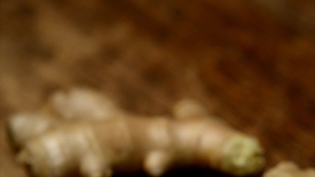 Ginger roots on a wooden table close up
