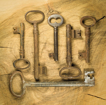 Group of old rusty keys on wood