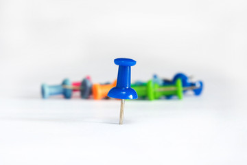 Blue push pin isolated on a white