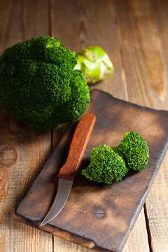Raw green broccoli on wooden background