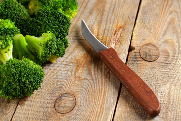 Raw broccoli on wooden background with copy space.