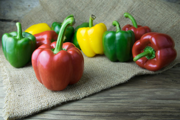Colored bell peppers on wooden table