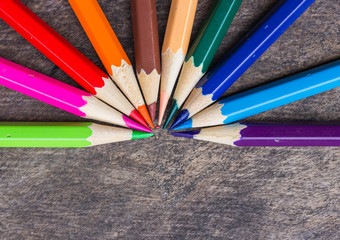 Fototapeta premium Color pencils on wood background
