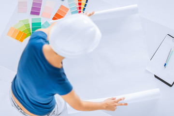 woman with color samples and blueprint