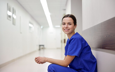 smiling female nurse at hospital corridor