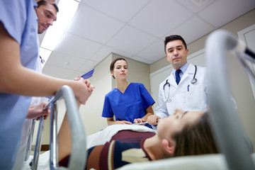 Fototapeta premium medics and patient on hospital gurney at emergency