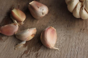 heap garlic on wood background