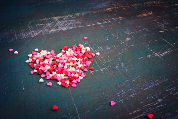 Valentines day colorful hearts on a dark shabby background. Tint