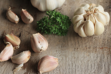 heap garlic on wood background