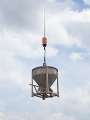 Crane lifting concrete mixer container