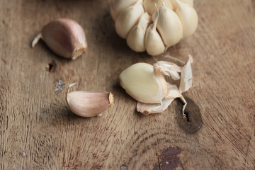 heap garlic on wood background