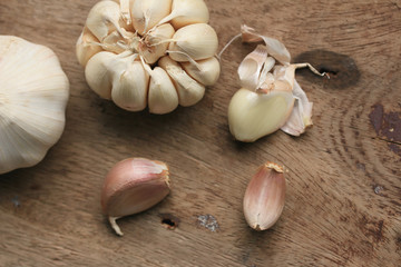 heap garlic on wood background