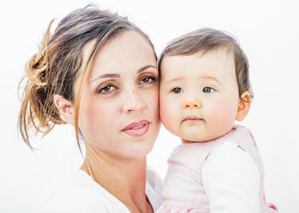 close-up of a smiling young woman with her baby on white background