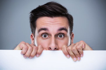 Man hiding behind a copy space