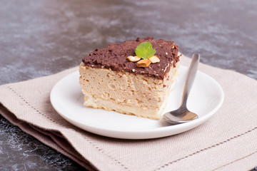 Cake of a souffle with glaze on a white plate. slice