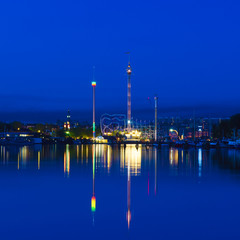 Grona Lund at night in Stockholm city with water reflection at the sea harbour
