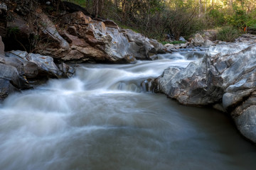 Naklejka premium creek flowing over the rocks