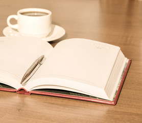 Notepad and pen on wooden table