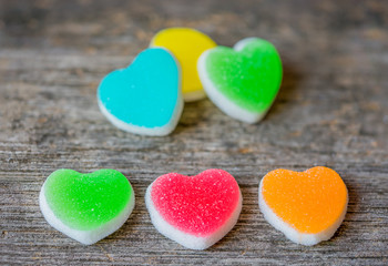 Obraz premium Colorful candy sweet hearts on wooden background.- Vintage filte
